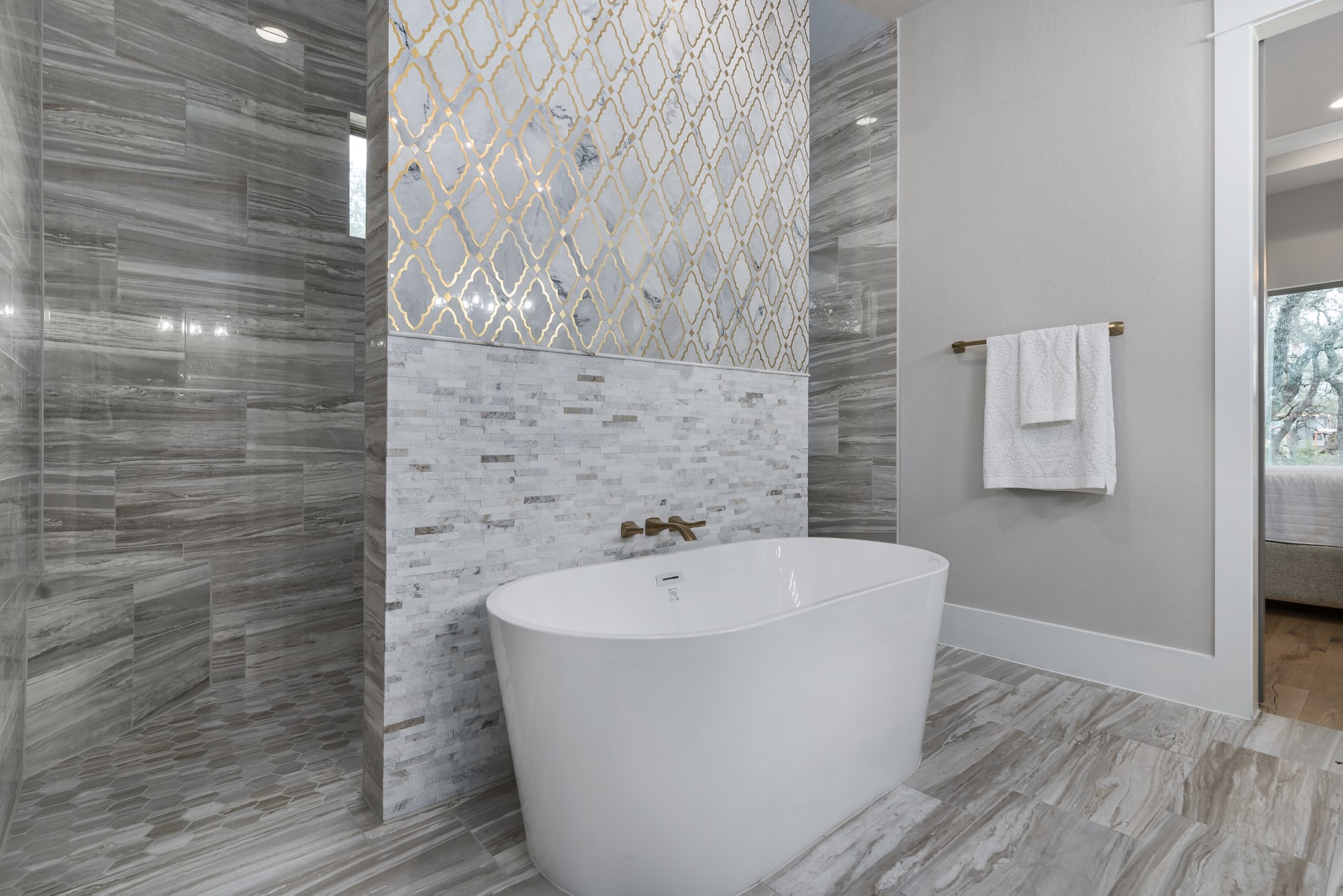 A side view of the bathroom tub and shower within the Belle Oaks custom floor plan from JLP Builders