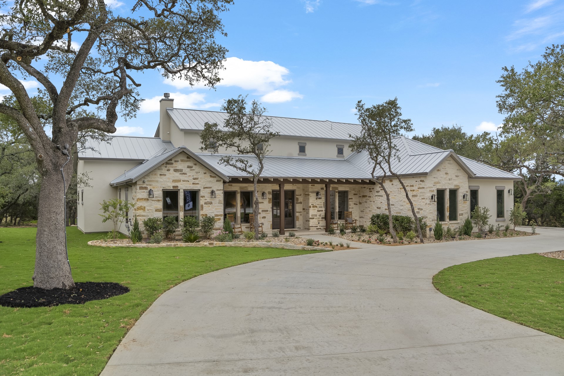 A side view of the front of the Belle Oaks custom home plan from JLP Builders