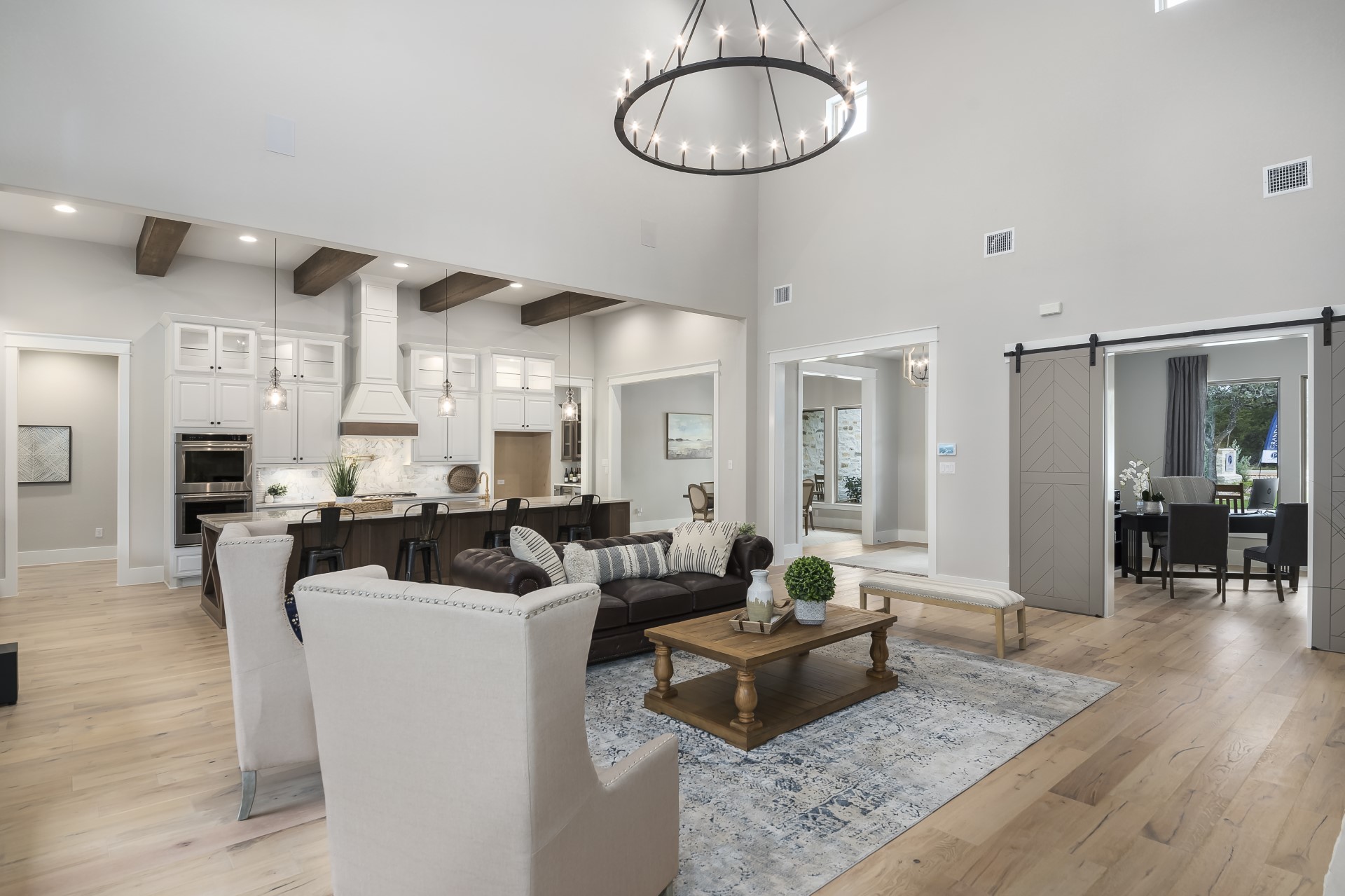 A front view of the living room, kitchen, and foyer living space within the Belle Oaks custom floor plan from JLP Builders