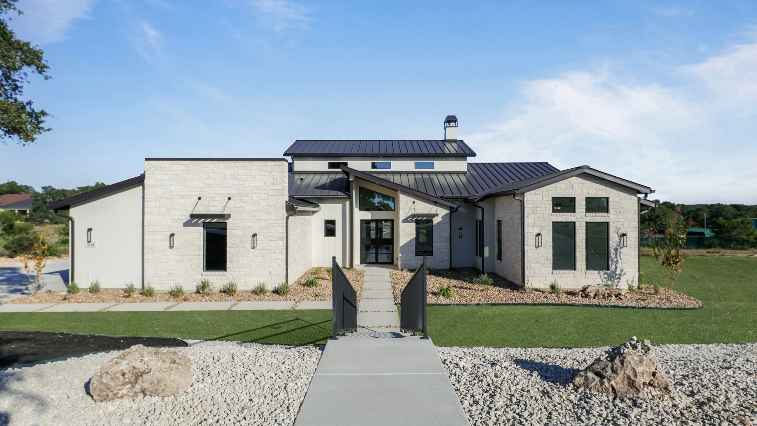 A side view of the front of the Belle Oaks custom home plan from JLP Builders